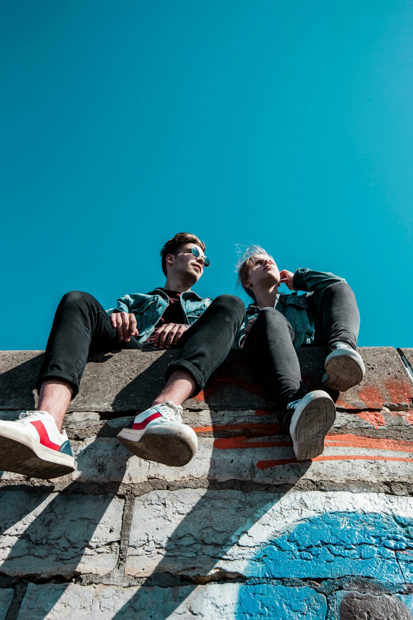 zwei Menschen auf Mauer